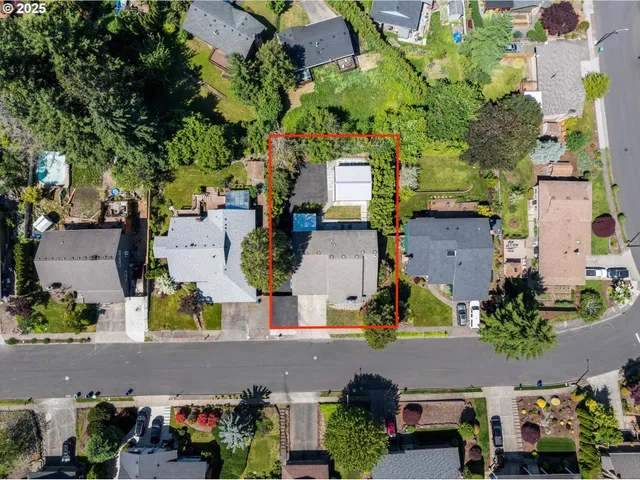an aerial view of a houses with yard