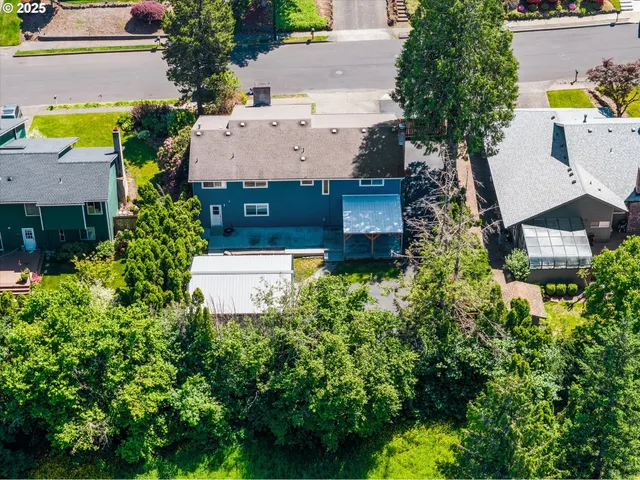an aerial view of a house with swimming pool and garden space