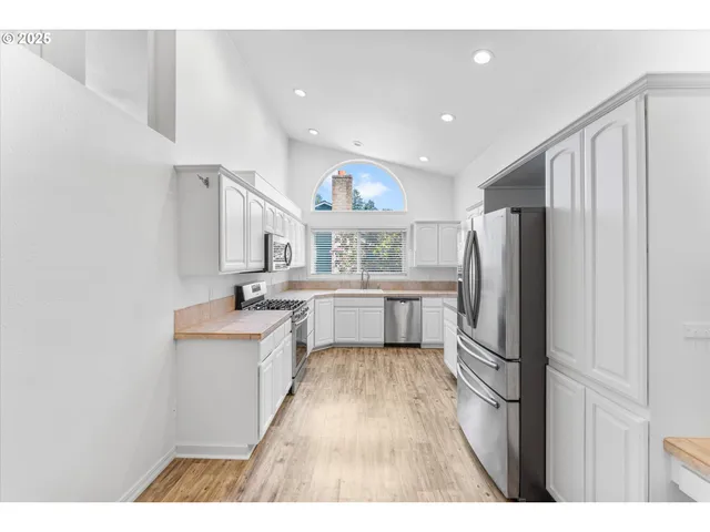 a kitchen with stainless steel appliances a refrigerator and a sink
