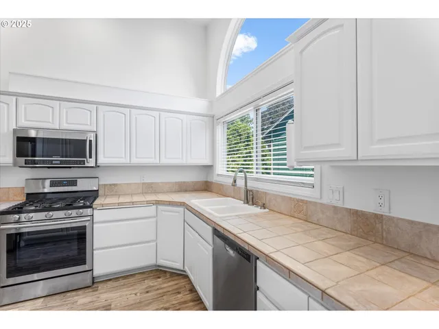 a kitchen with a sink stove and microwave