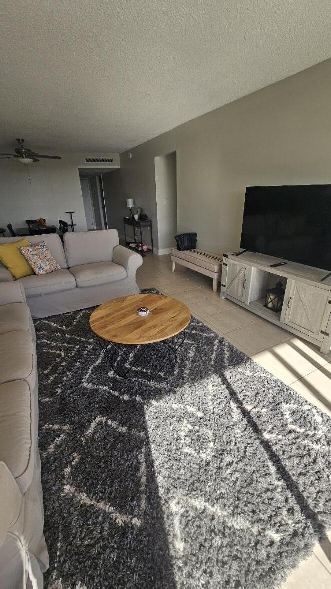 4 Royal Palm Way, Unit 6050 Boca Raton, FL 33432 - Photo 12 of 35 a living room with furniture a flat screen tv and a fireplace