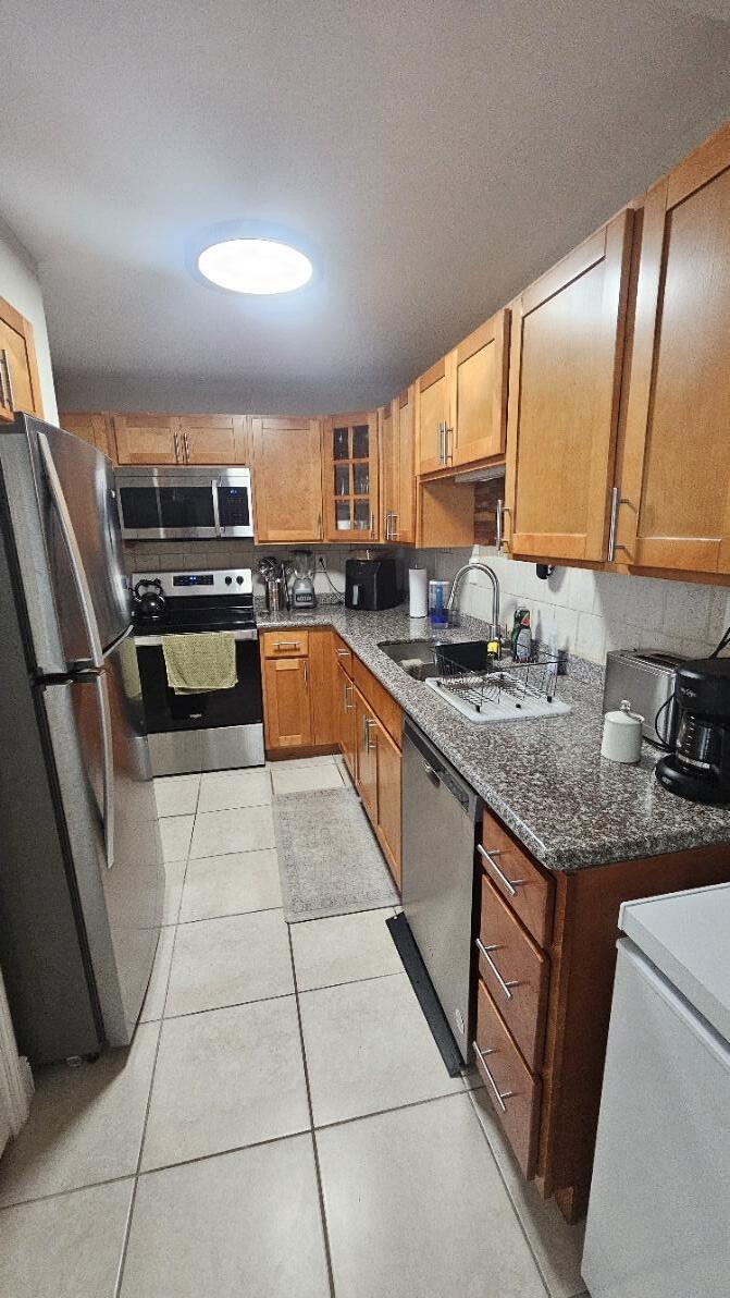 4 Royal Palm Way, Unit 6050 Boca Raton, FL 33432 - Photo 13 of 35 a kitchen with stainless steel appliances granite countertop a sink stove and cabinets