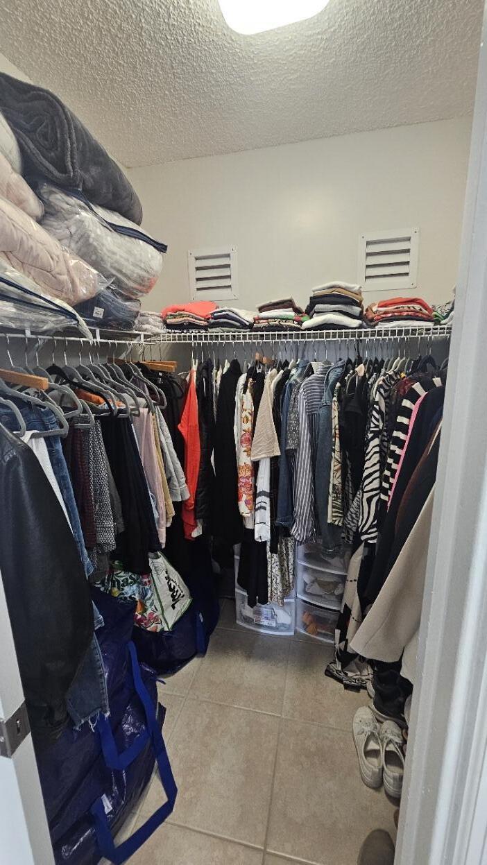 4 Royal Palm Way, Unit 6050 Boca Raton, FL 33432 - Photo 24 of 35 a view of walk in closet with clothes and shoes