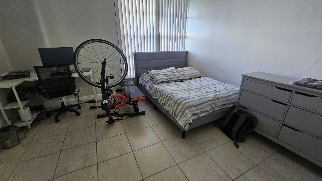 4 Royal Palm Way, Unit 6050 Boca Raton, FL 33432 - Photo 26 of 35 a bedroom with bed and a chandelier