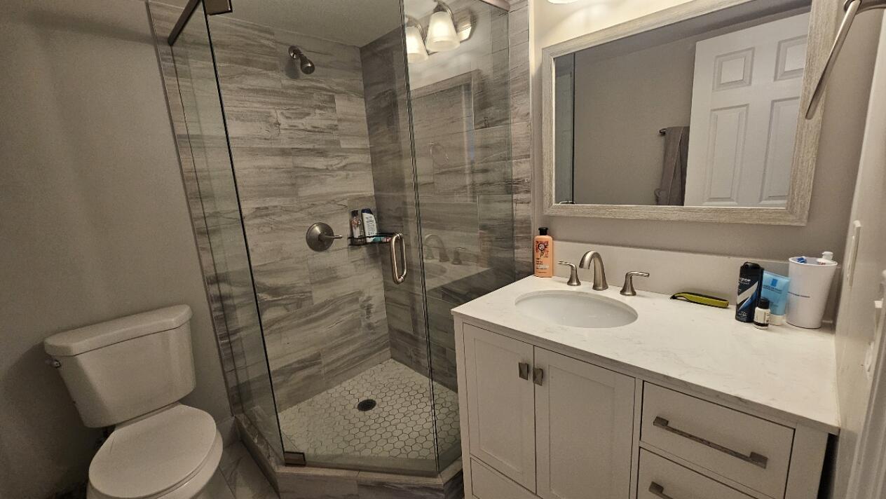 4 Royal Palm Way, Unit 6050 Boca Raton, FL 33432 - Photo 28 of 35 a bathroom with a sink toilet and shower