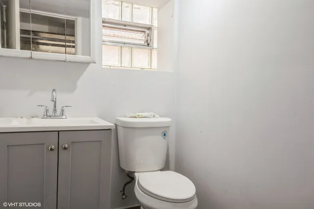 a white toilet sitting next to a bathroom sink