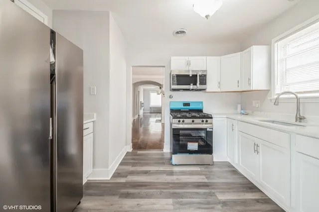 a kitchen with stainless steel appliances a stove sink and refrigerator