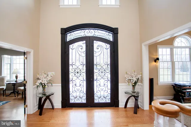 a kitchen with stainless steel appliances kitchen island granite countertop a refrigerator a stove and a sink with wooden floor