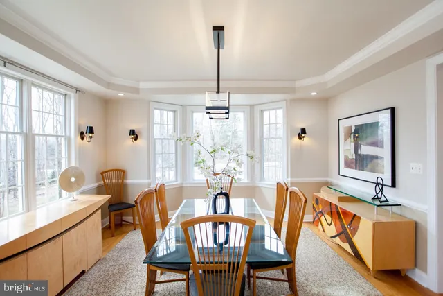 a living room with furniture a flat screen tv and a window