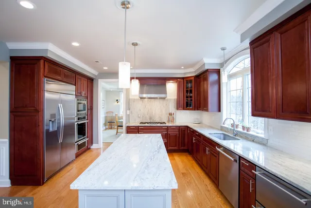 a view of livingroom with furniture staircase wooden floor and windows