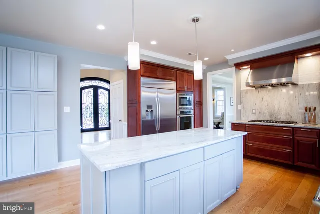 a living room with furniture fireplace and a large window