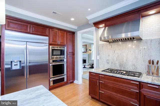 a bathroom with a granite countertop double sink and a mirror