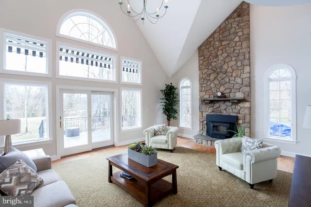 a living room with furniture potted plant and a flat screen tv