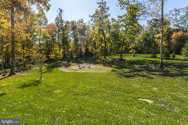 a view of a patio with a table and chairs and floor to ceiling window