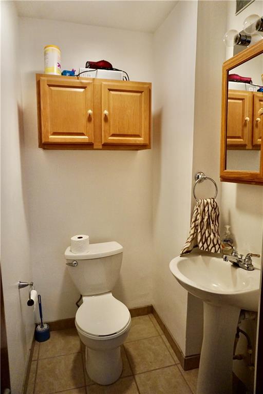 455 Old Plank Road Butler, PA 16002 - Photo 12 of 25 a bathroom with a toilet a sink and mirror
