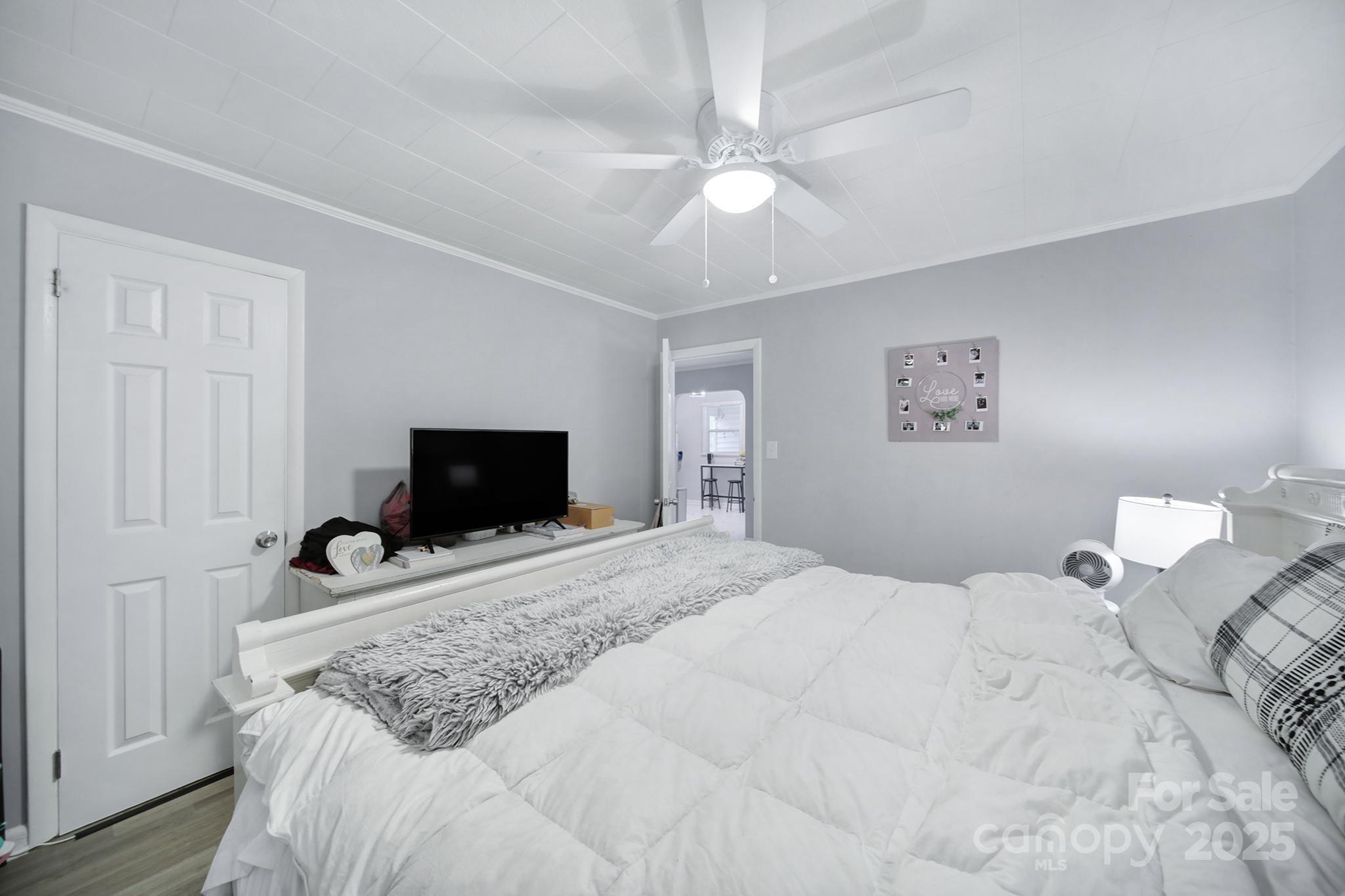 1306 Church Street Lancaster, SC 29720 - Photo 15 of 26 a bedroom with a bed and a flat screen tv