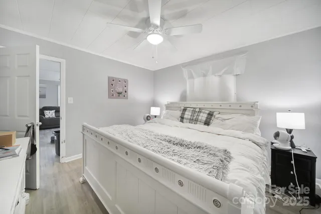 a bedroom with a bed and a chandelier