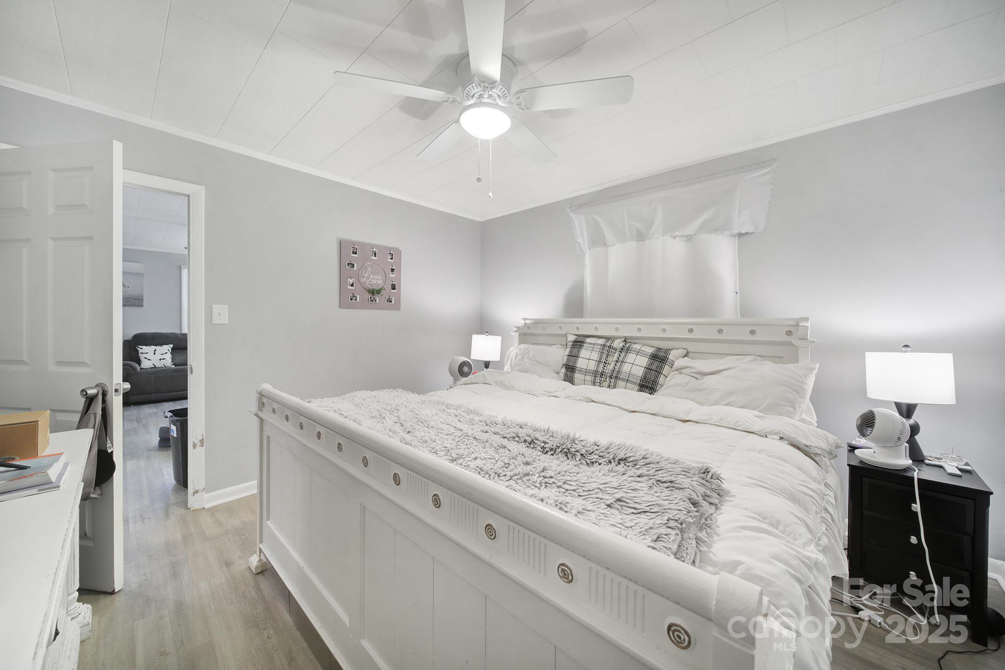 1306 Church Street Lancaster, SC 29720 - Photo 16 of 26 a bedroom with a bed and a chandelier