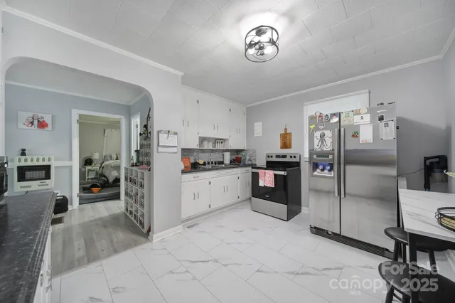 a kitchen with a refrigerator and microwave