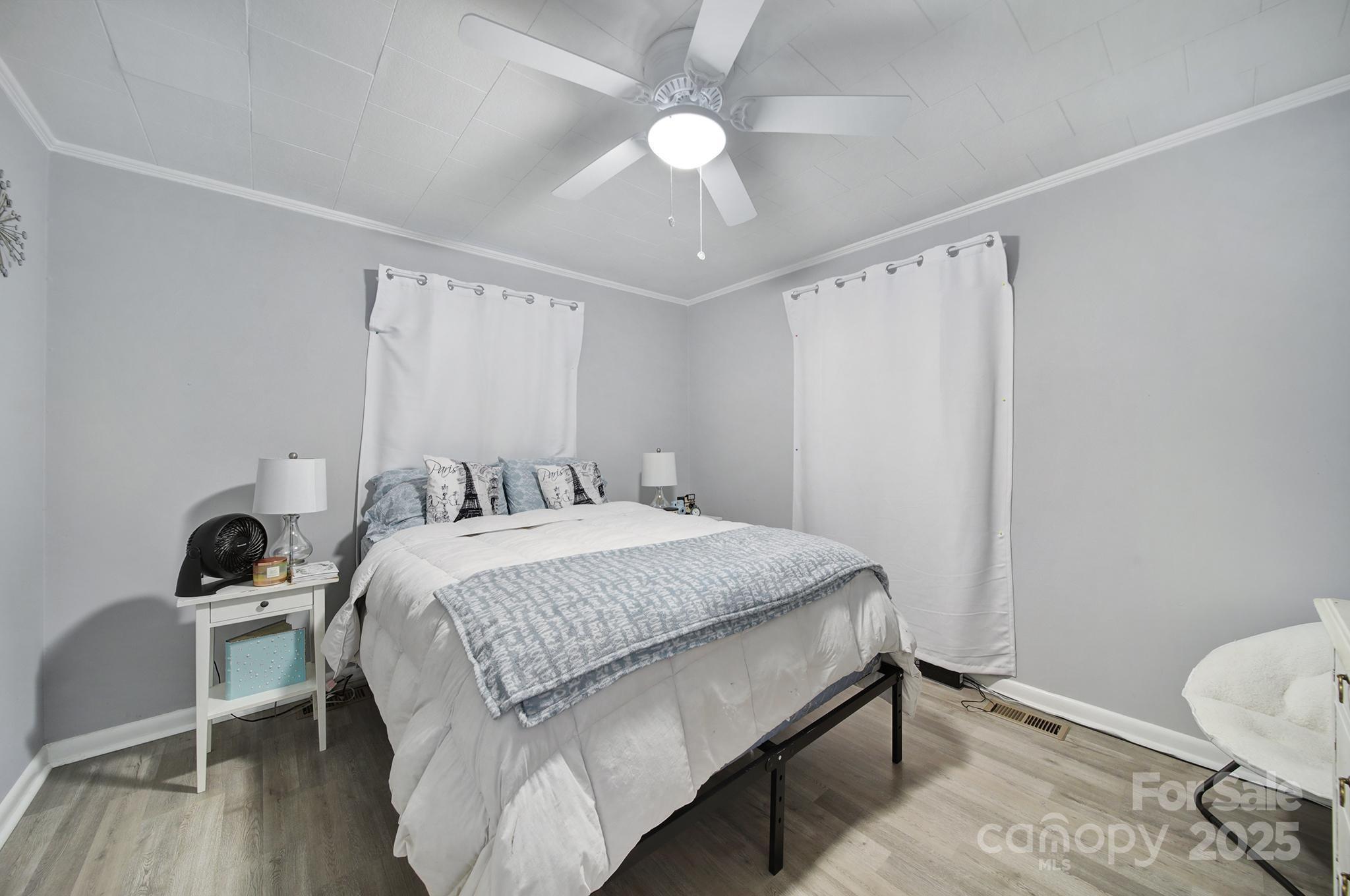 1306 Church Street Lancaster, SC 29720 - Photo 19 of 26 a bedroom with a bed and a chandelier