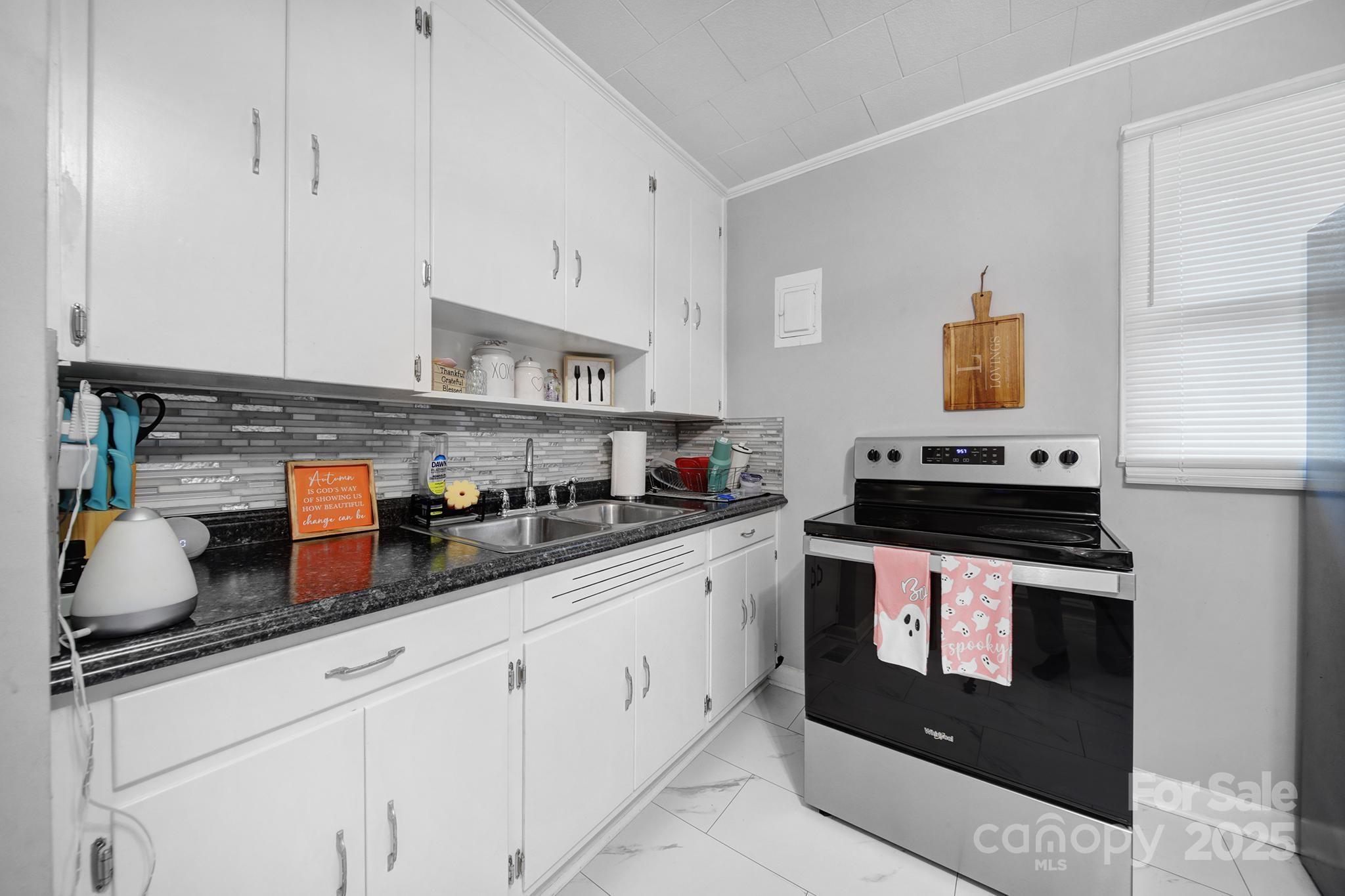 1306 Church Street Lancaster, SC 29720 - Photo 7 of 26 a kitchen with stainless steel appliances granite countertop a sink stove and cabinets