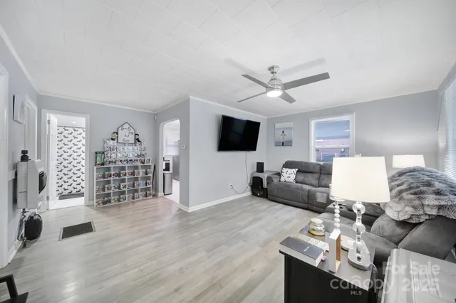 a living room with furniture a rug and a flat screen tv