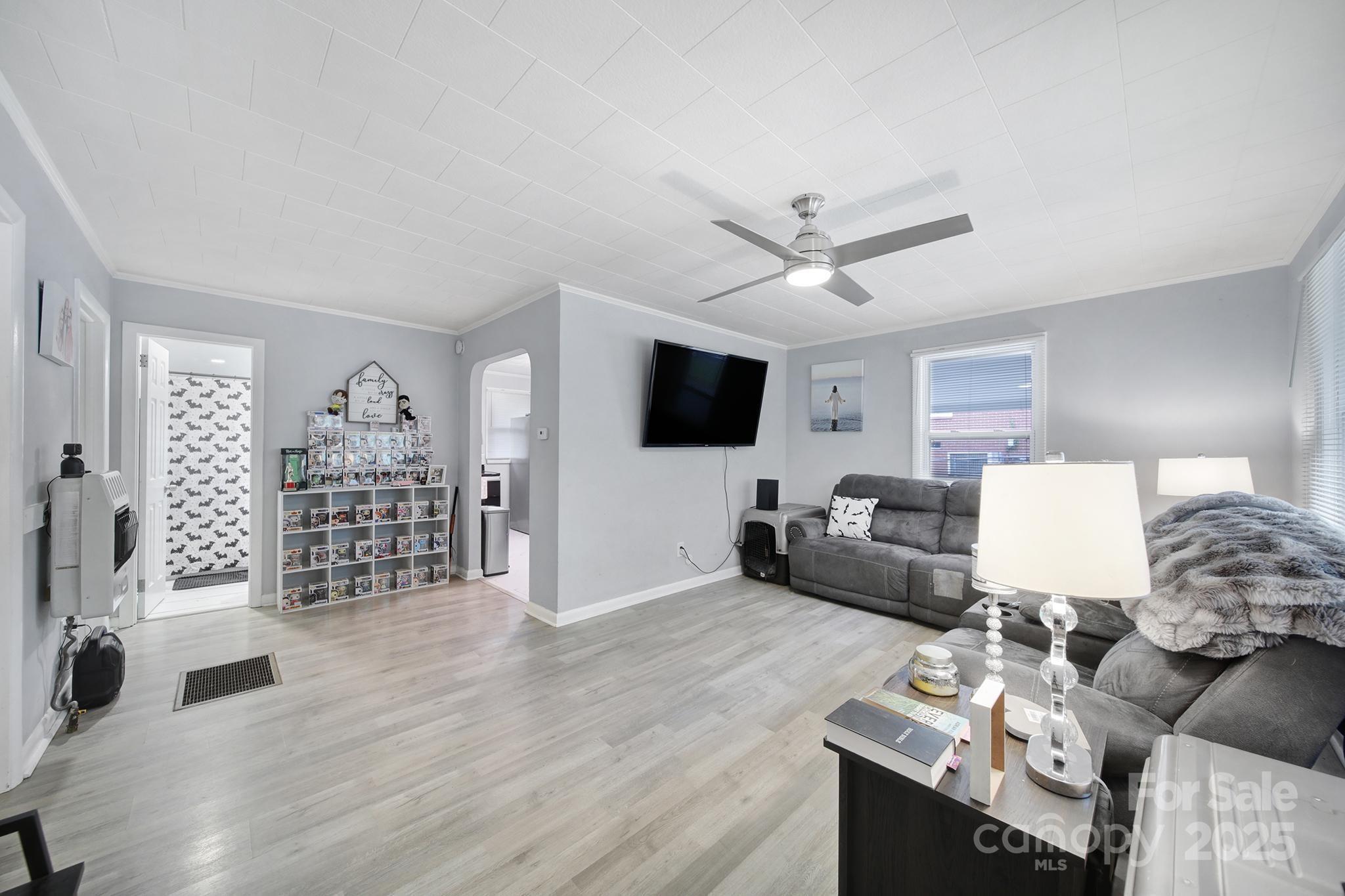 1306 Church Street Lancaster, SC 29720 - Photo 10 of 26 a living room with furniture a rug and a flat screen tv