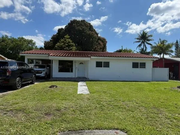 a view of a house with a swimming pool and a yard