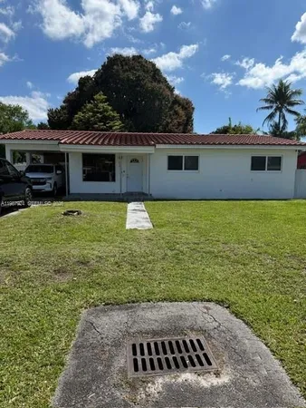 a view of a house with yard from a kitchen