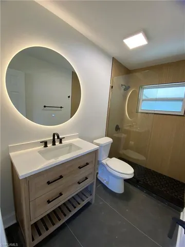 a bathroom with a sink mirror and toilet