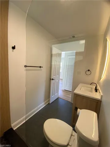 a bathroom with a toilet a sink and bathtub