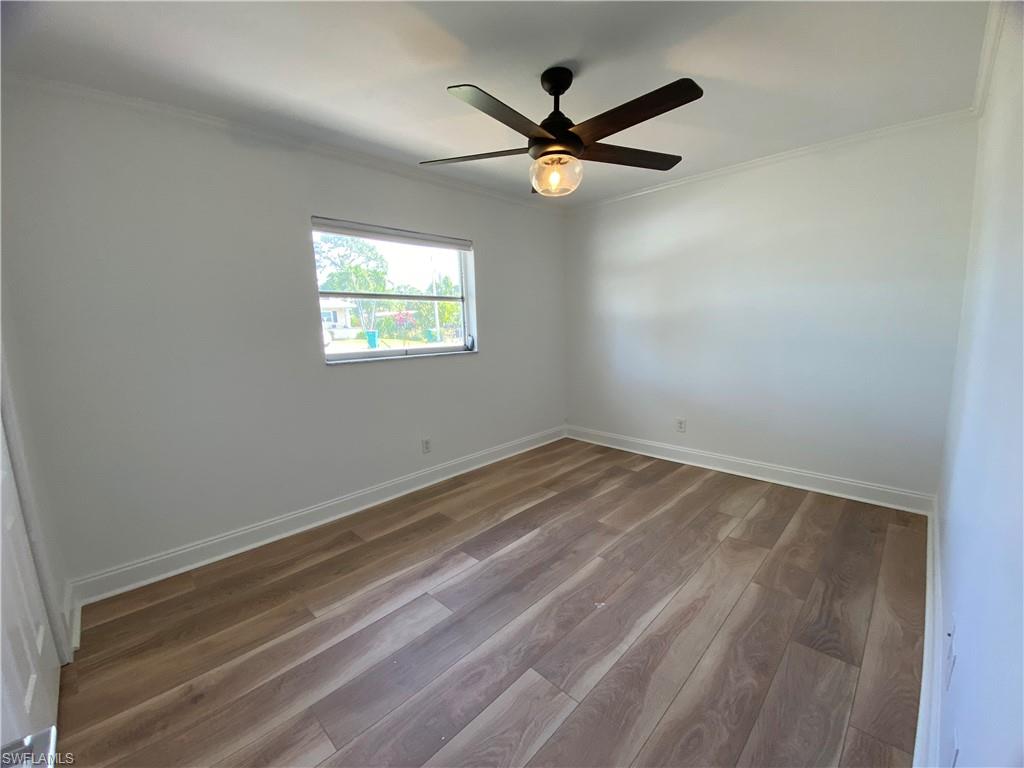 740 108th Avenue North Naples, FL 34108 - Photo 18 of 26 an empty room with a window and a ceiling fan
