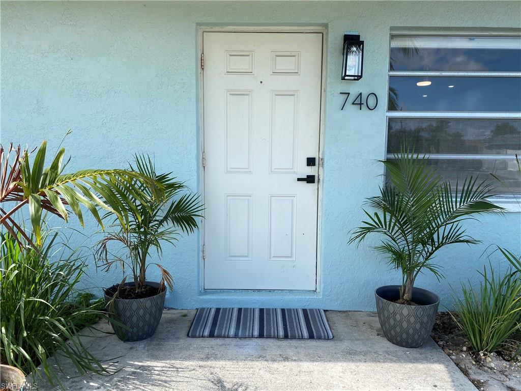 740 108th Avenue North Naples, FL 34108 - Photo 2 of 26 a potted plant sitting in a room next to a potted plant