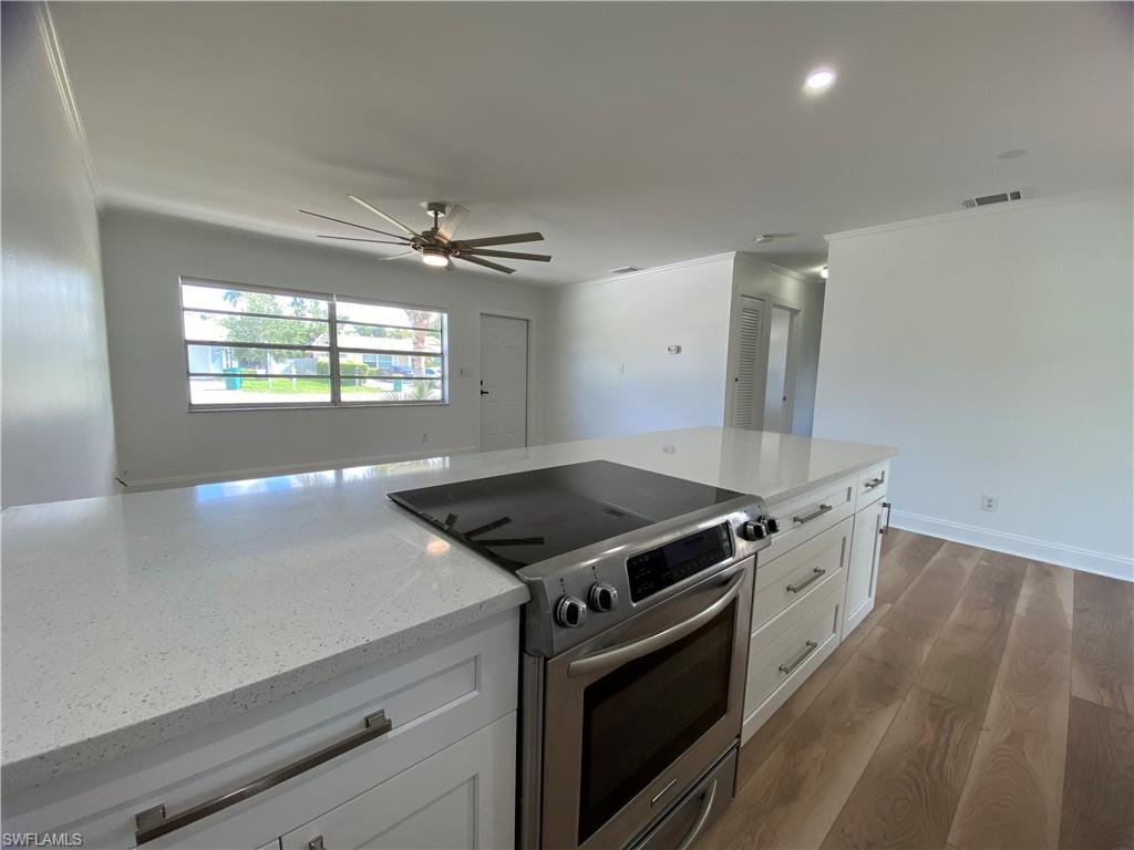 740 108th Avenue North Naples, FL 34108 - Photo 10 of 26 an open kitchen with stove and cabinets