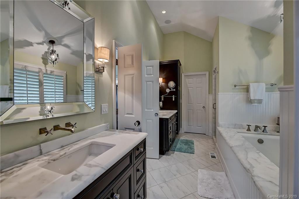 859 Museum Drive Charlotte, NC 28207 - Photo 14 of 23 a spacious bathroom with a tub sink and mirror