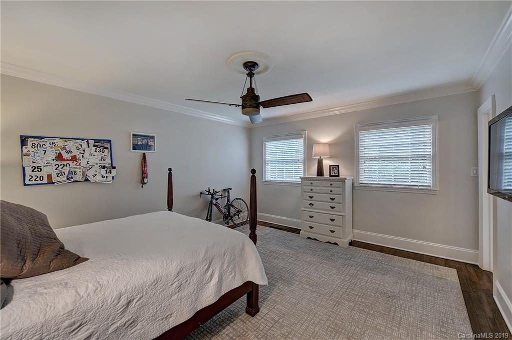 859 Museum Drive Charlotte, NC 28207 - Photo 16 of 23 a bedroom with a bed and a chandelier