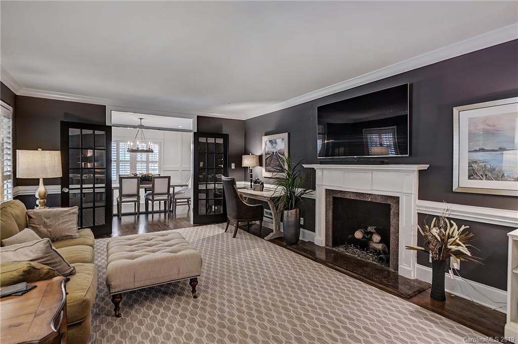 859 Museum Drive Charlotte, NC 28207 - Photo 5 of 23 a living room with furniture a flat screen tv and a fireplace