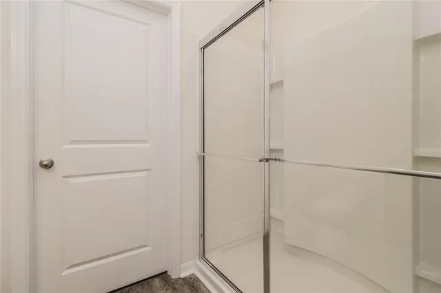 a bathroom with a glass shower door