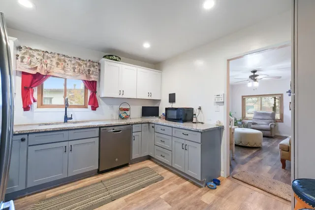 a kitchen with stainless steel appliances granite countertop a refrigerator stove microwave and sink