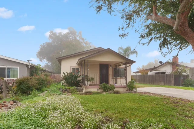 a front view of house with yard and green space