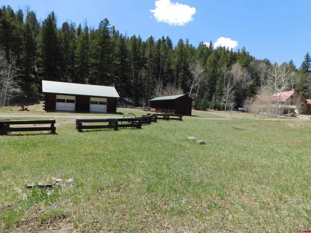 a view of a house with backyard and sitting area