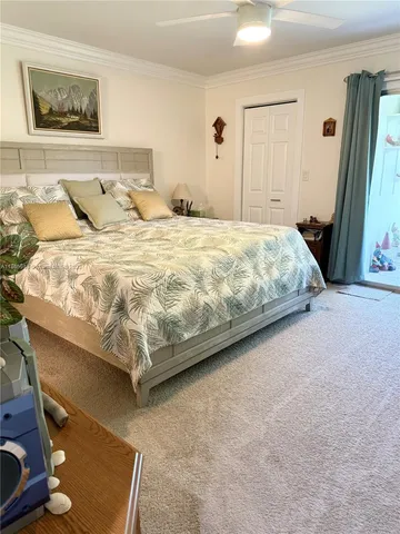 a large bed sitting in a bedroom next to a window