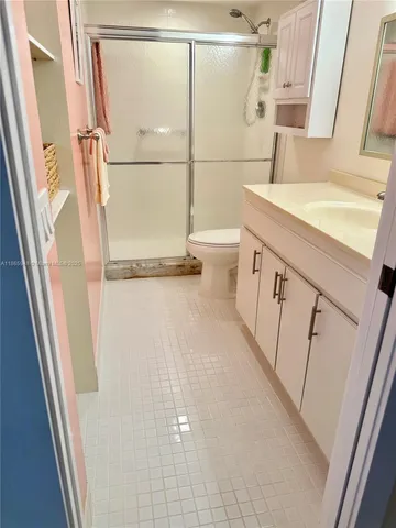 a view of swimming pool with seating area and trees in the background