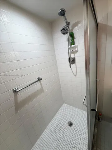 a view of a deck with a floor to ceiling window and a swimming pool