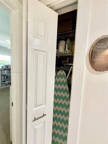 a view of a big room with wooden floor and windows