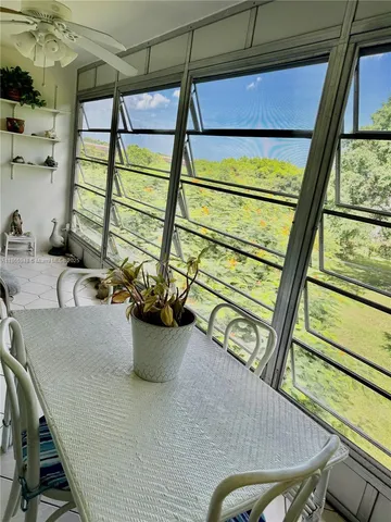 an aerial view of a houses with outdoor space and trees