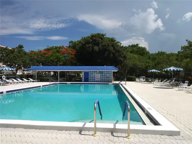 an aerial view of ocean with residential house and outdoor space