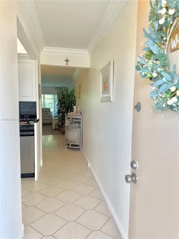a view of a hallway with furniture and a potted plant