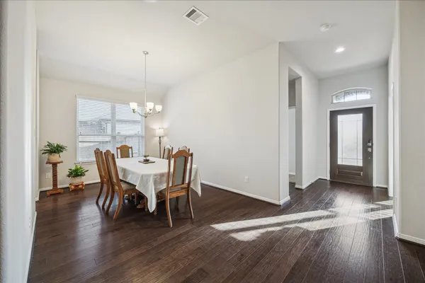 a kitchen with kitchen island granite countertop wooden floors and stainless steel appliances