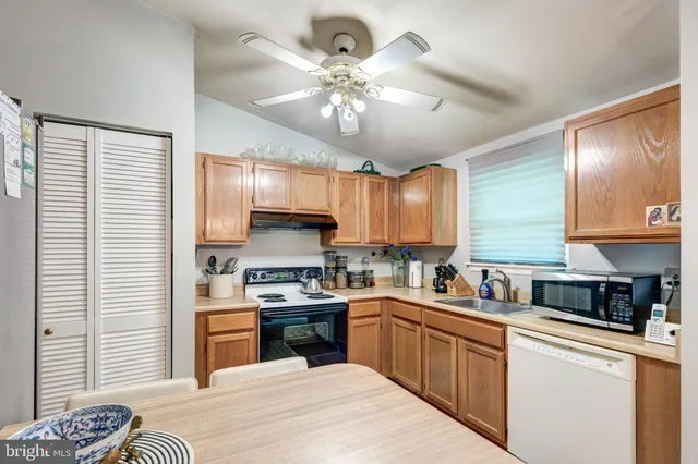 a kitchen with stove a sink and cabinets